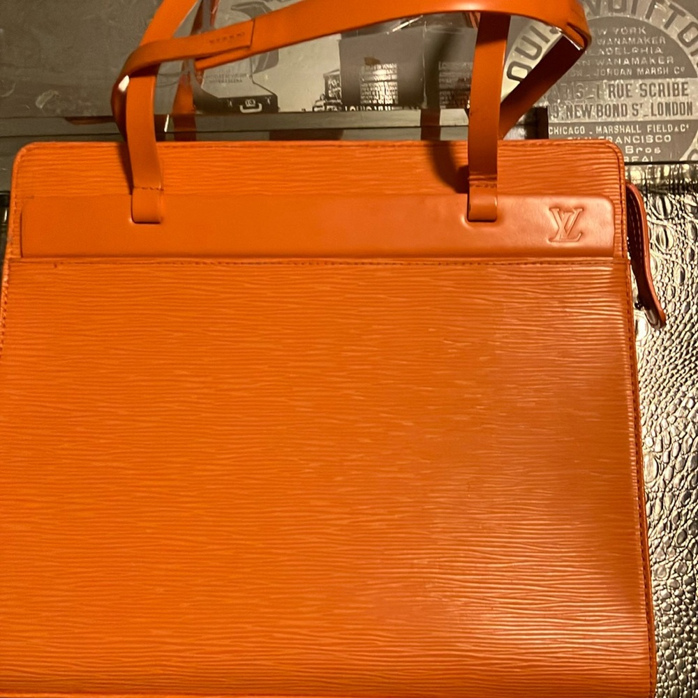 Vintage authentic Louis Vuitton tangerine EPI leather.